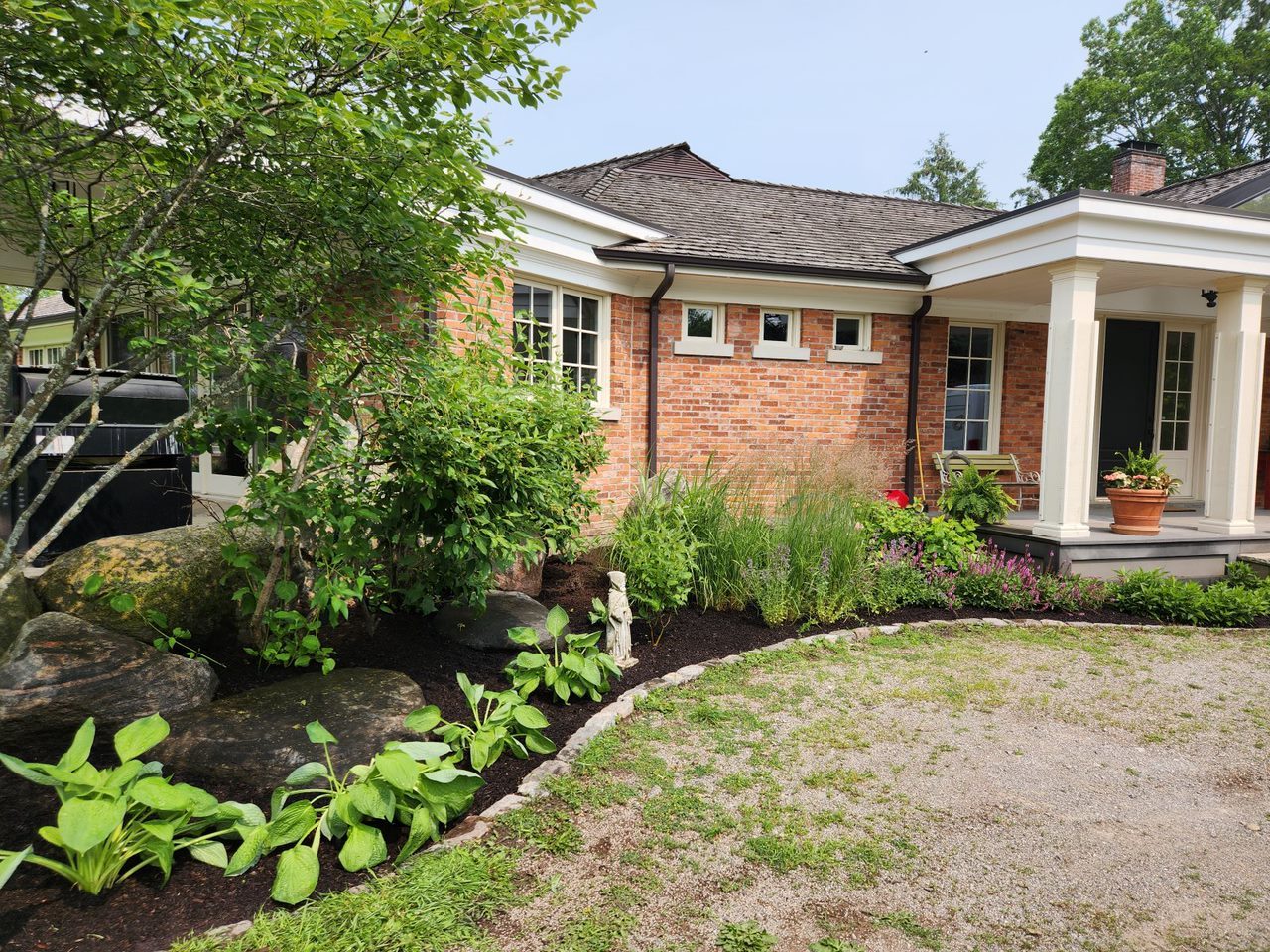 Brick house with lush garden landscape