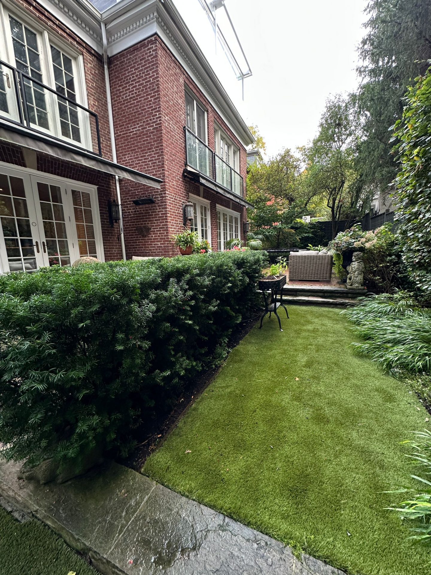 Brick house with lush green backyard
