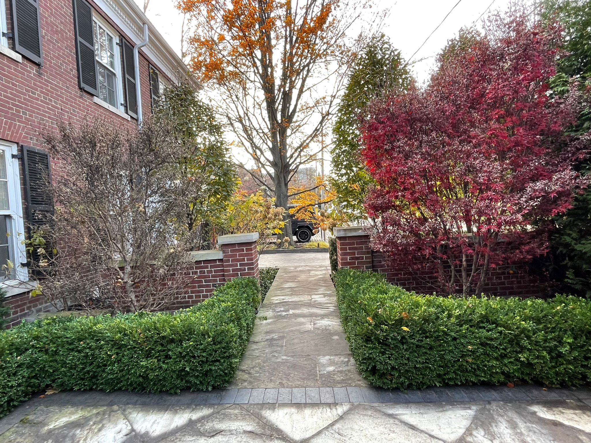 Brick home with path and autumn trees
