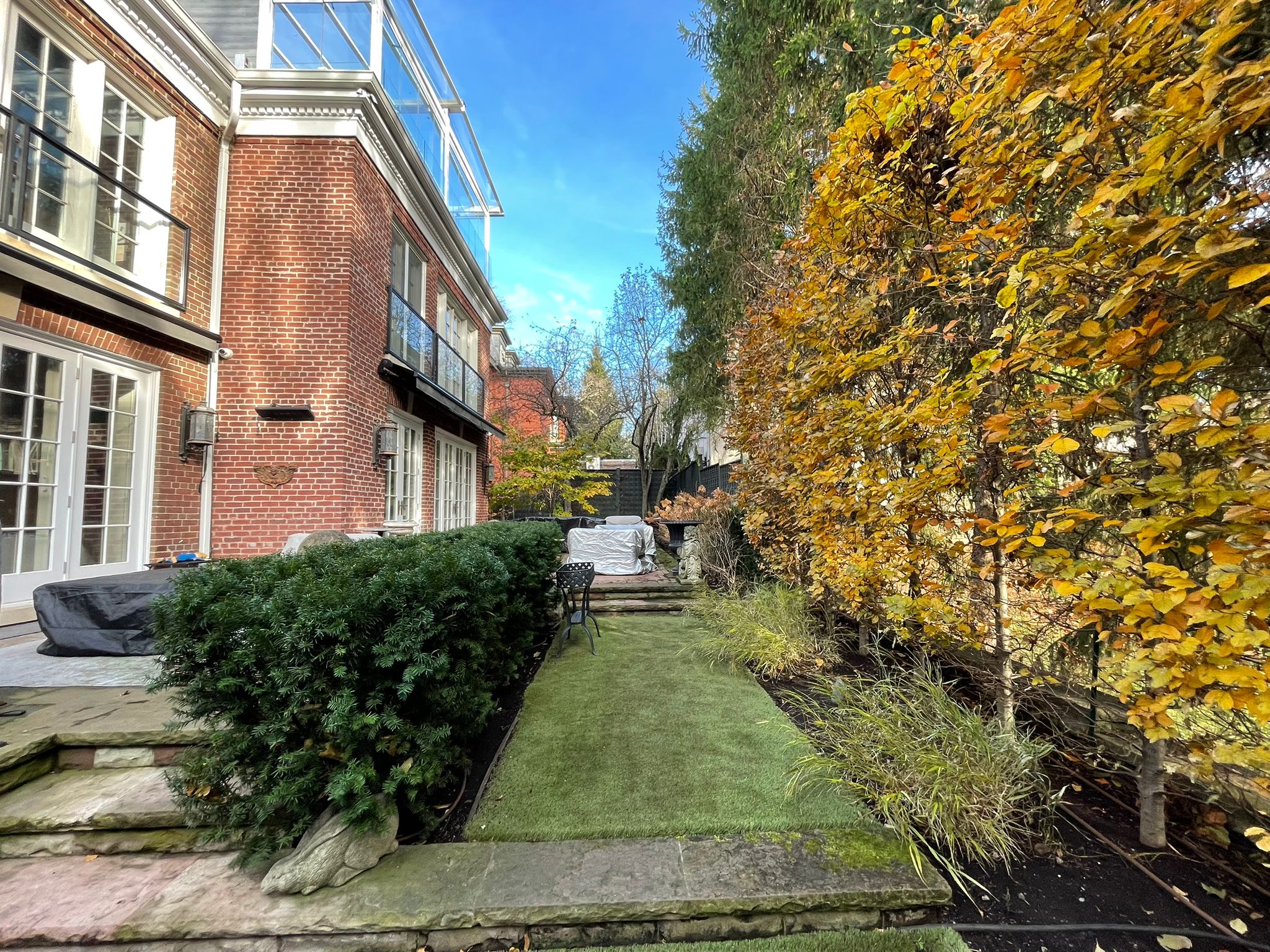 Autumn garden beside brick house