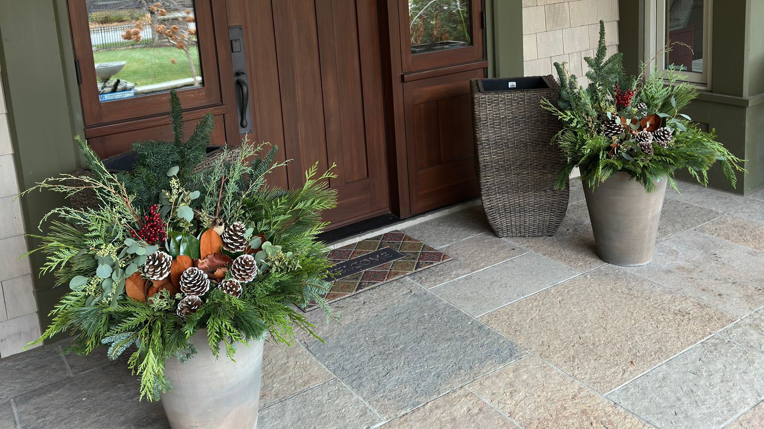 Outdoor planters with pine cones and greenery