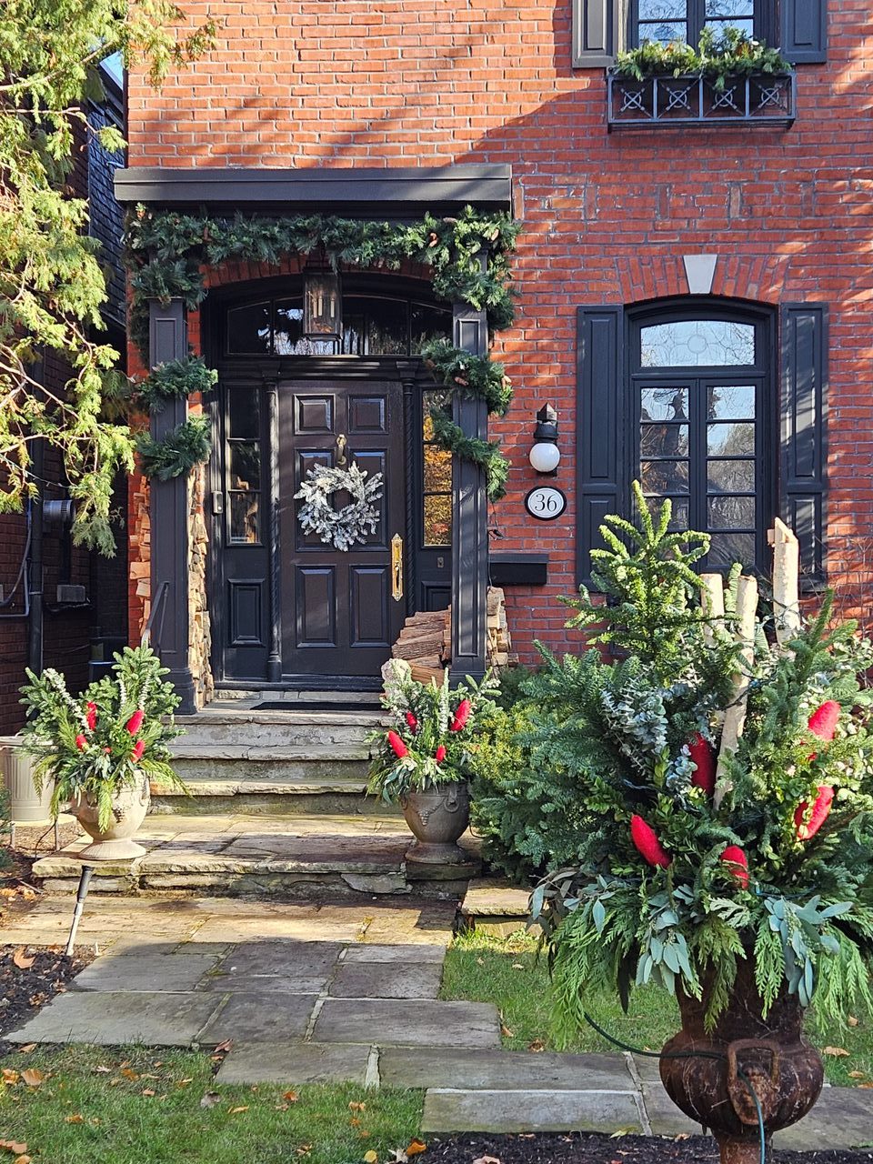 Festive wreath and greenery on house front door.