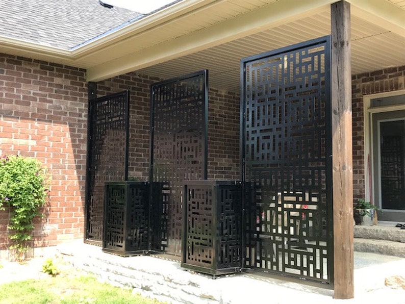 Decorative metal privacy screens on brick patio