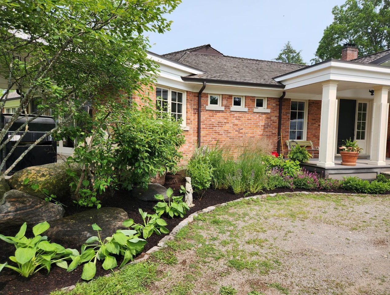 Brick house with lush garden landscaping