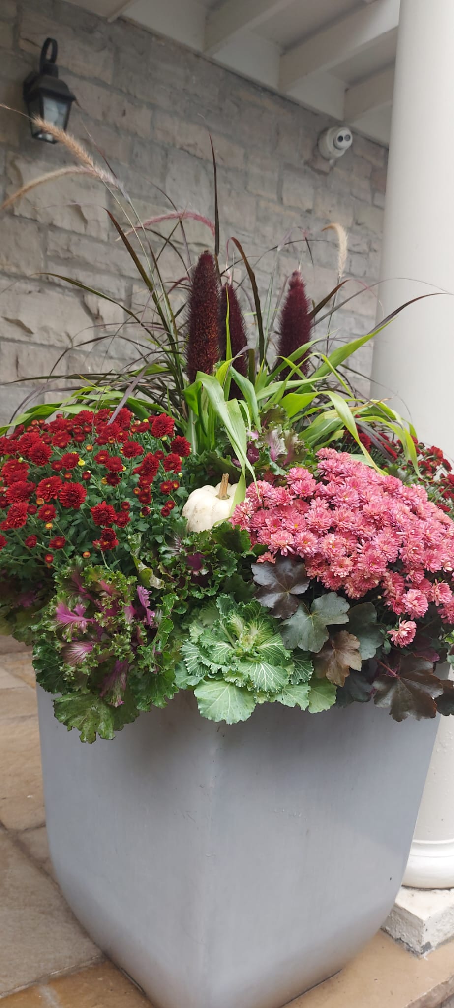Colorful flower arrangement in a white planter.